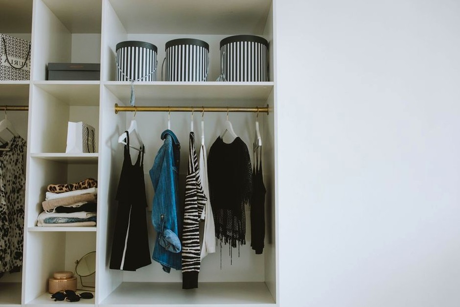 A neatly arranged wardrobe with everyday clothes and storage.