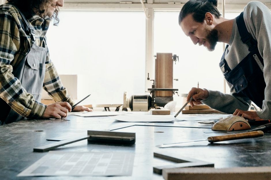 People working together at a hands-on craft table.